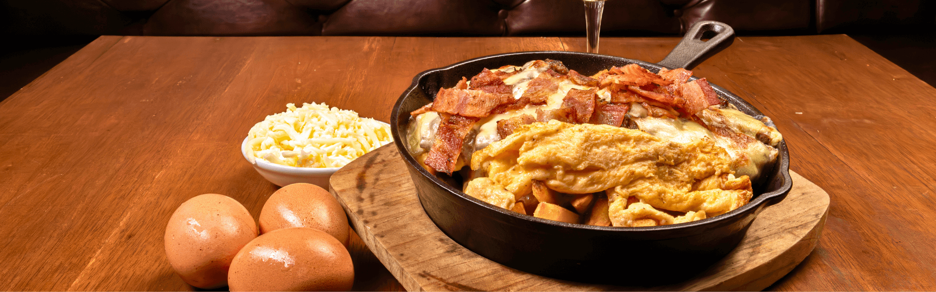 Bed of French fries, topped with beef, scrambled eggs, breakfast sausage, cheese, served at Big Boys’ Burger Club in Kamala, Patong and Rawai Beach