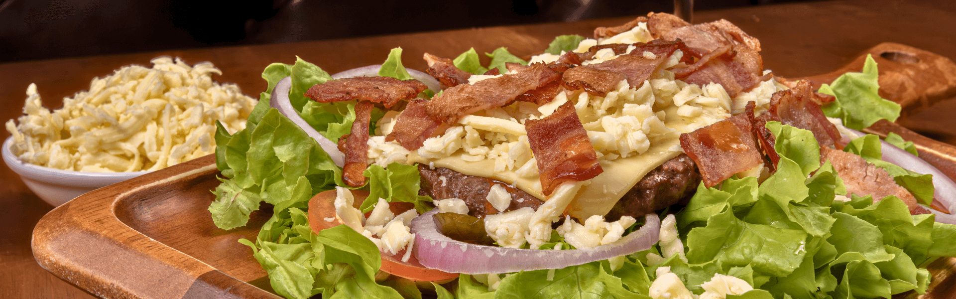 Two beef patties covered with cheddar cheese and bacon on fresh salad, served at Big Boys