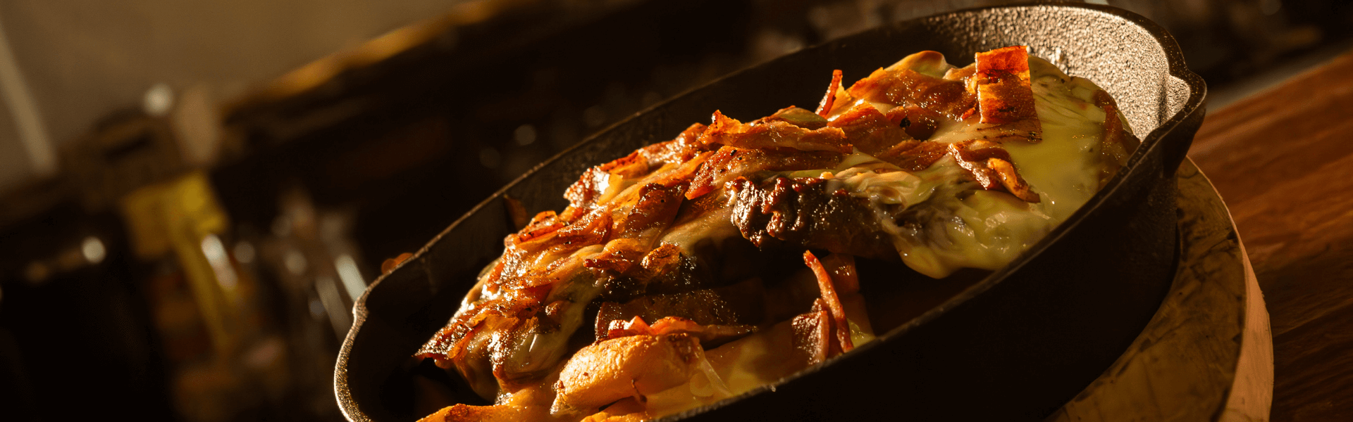 Bed of French fries, topped with beef, cheddar cheese and bacon, served at Big Boys’ Burger Club in Kamala, Patong and Rawai Beach